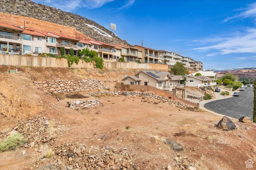 View of property with a mountain view and a residential view