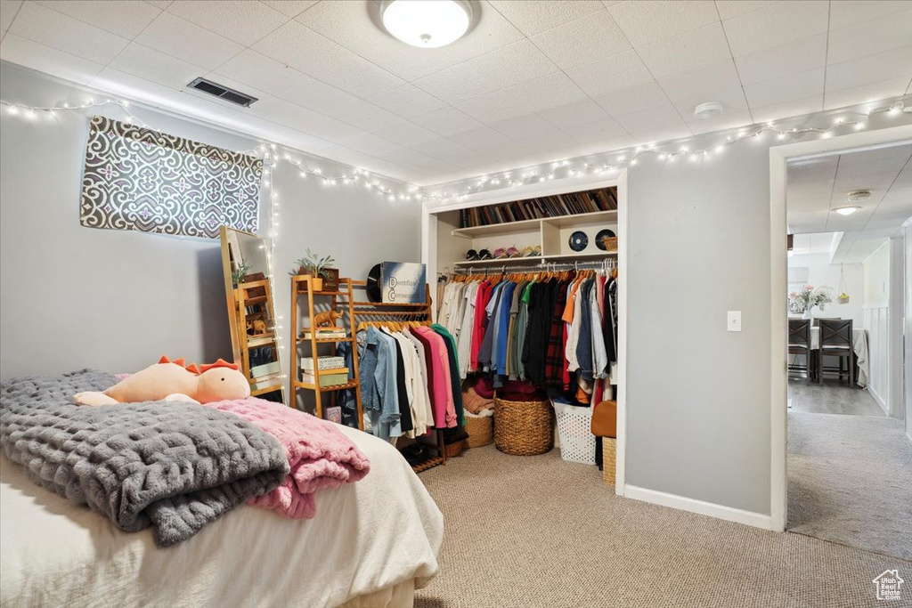 Carpeted bedroom featuring a closet