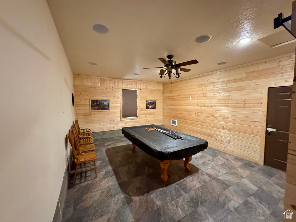 Recreation room with wooden walls, ceiling fan, pool table, and recessed lighting