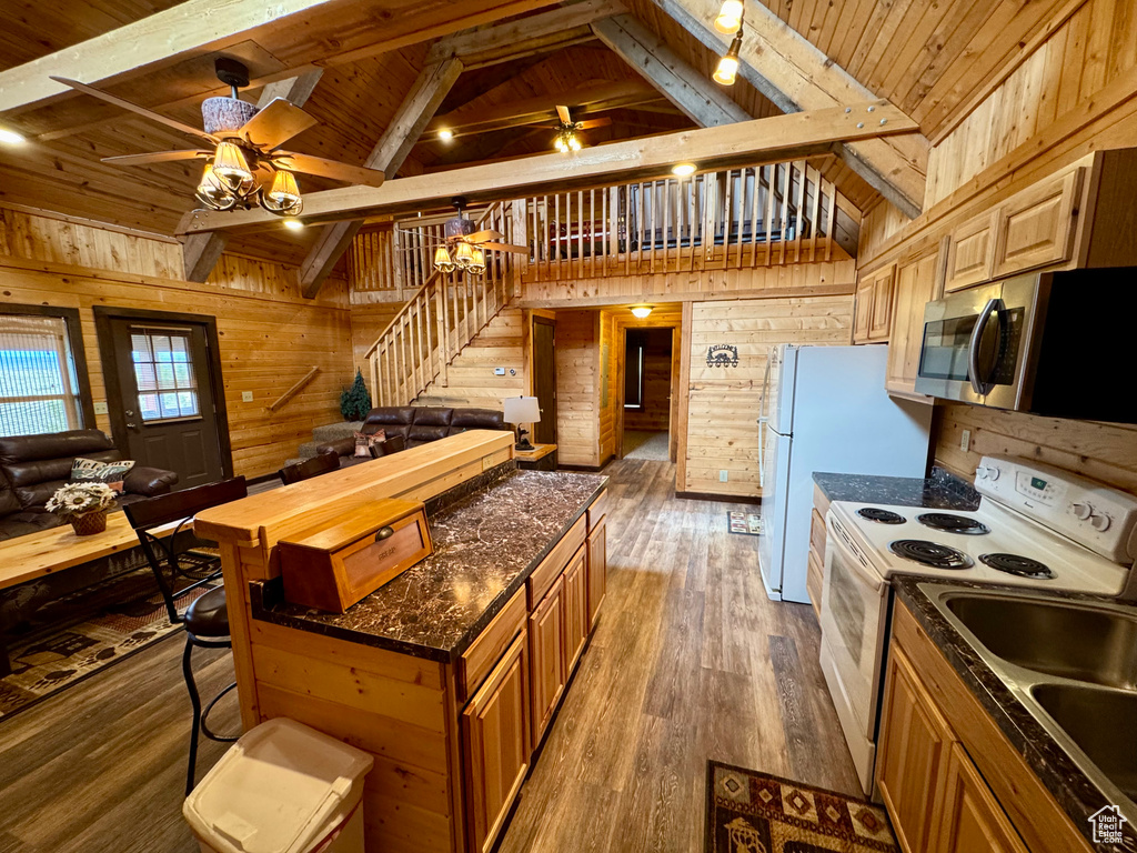 Kitchen featuring stainless steel microwave, a ceiling fan, white electric range, wooden walls, and wooden ceiling