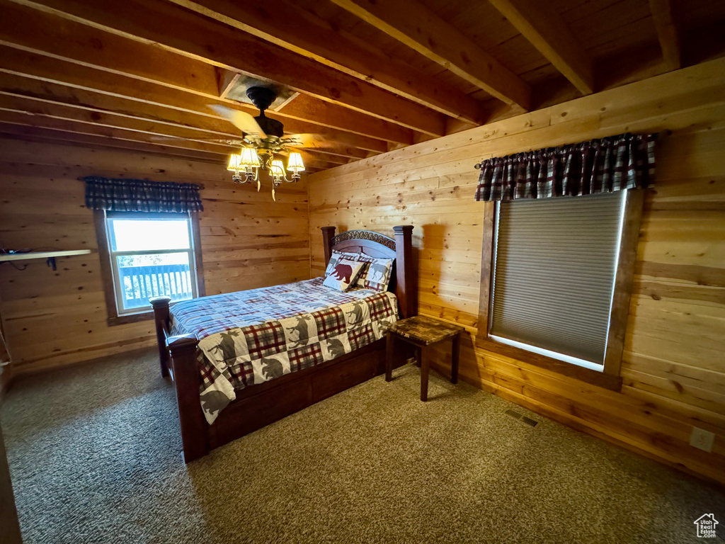 Carpeted bedroom with wooden walls