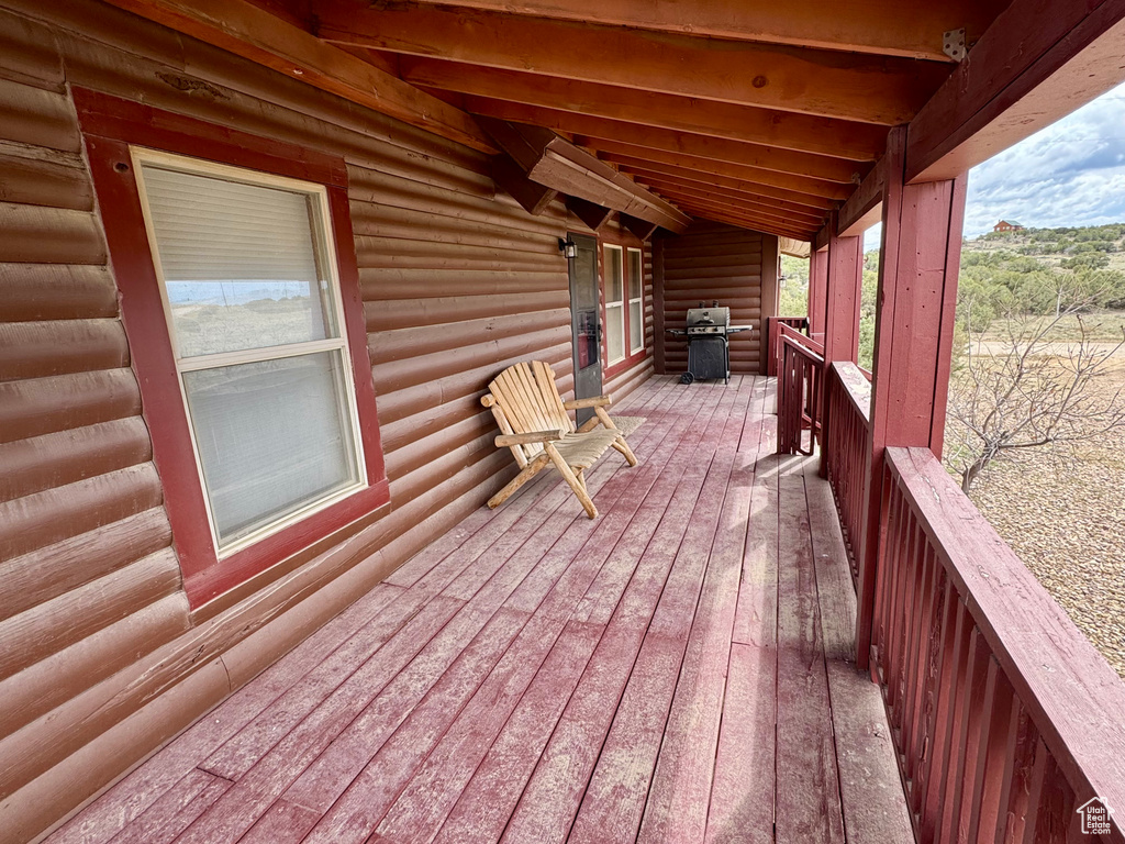 Wooden deck featuring area for grilling
