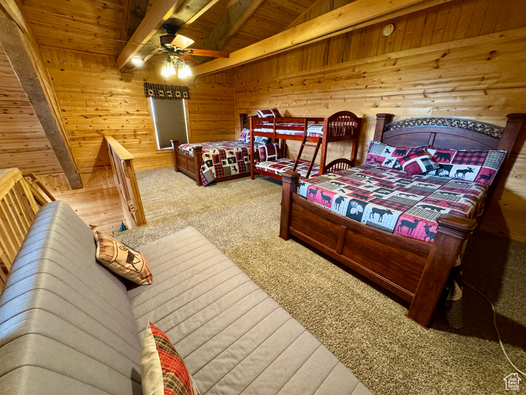 Bedroom featuring wood ceiling, carpet flooring, and wood walls