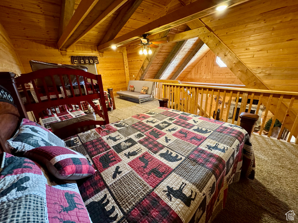 Carpeted bedroom with wood walls and wooden ceiling