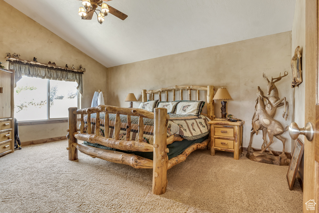 Carpeted bedroom featuring lofted ceiling