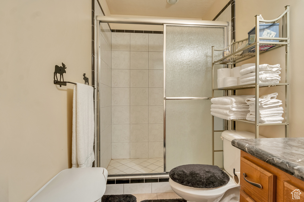 Full bath featuring toilet, a shower stall, and vanity