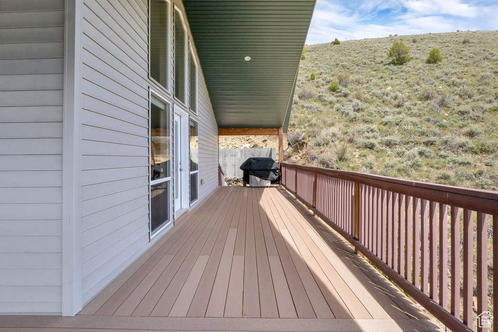 Wooden deck featuring a grill
