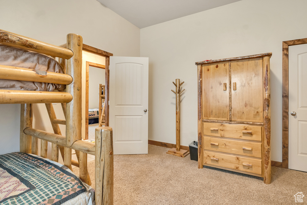 Bedroom with light colored carpet and baseboards