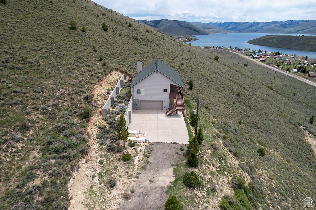 View of subject property with a water and mountain view