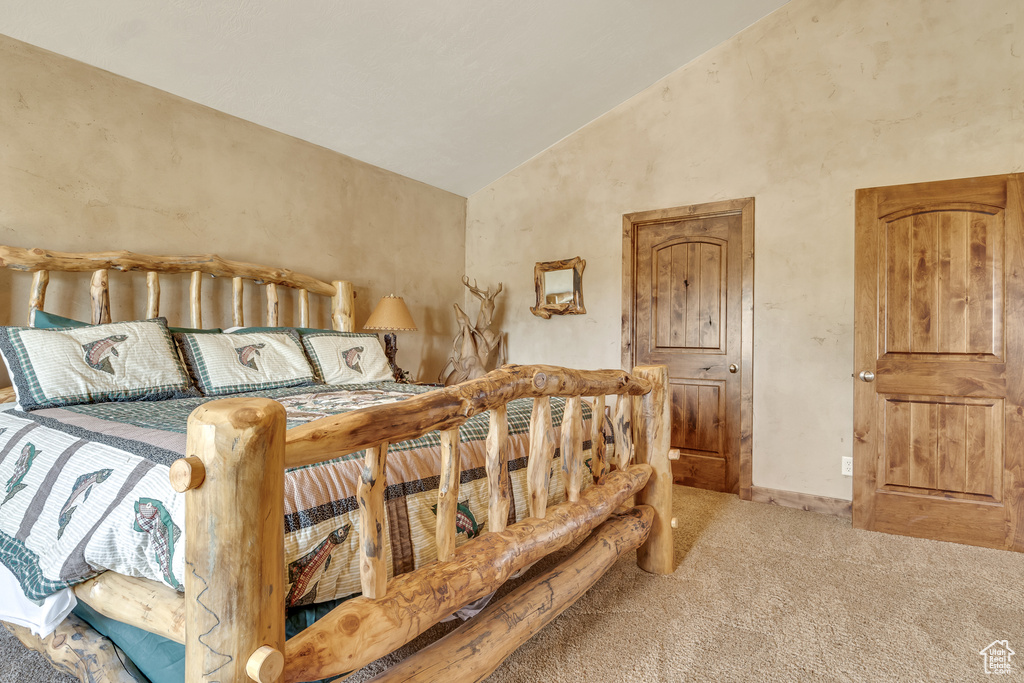 Bedroom featuring carpet floors, high vaulted ceiling, and baseboards