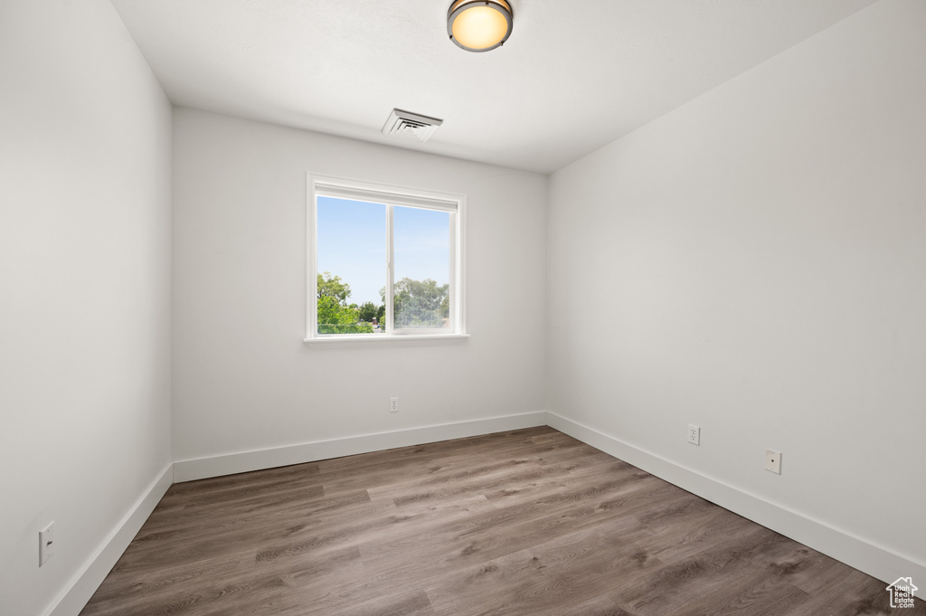 Unfurnished room with baseboards and wood finished floors