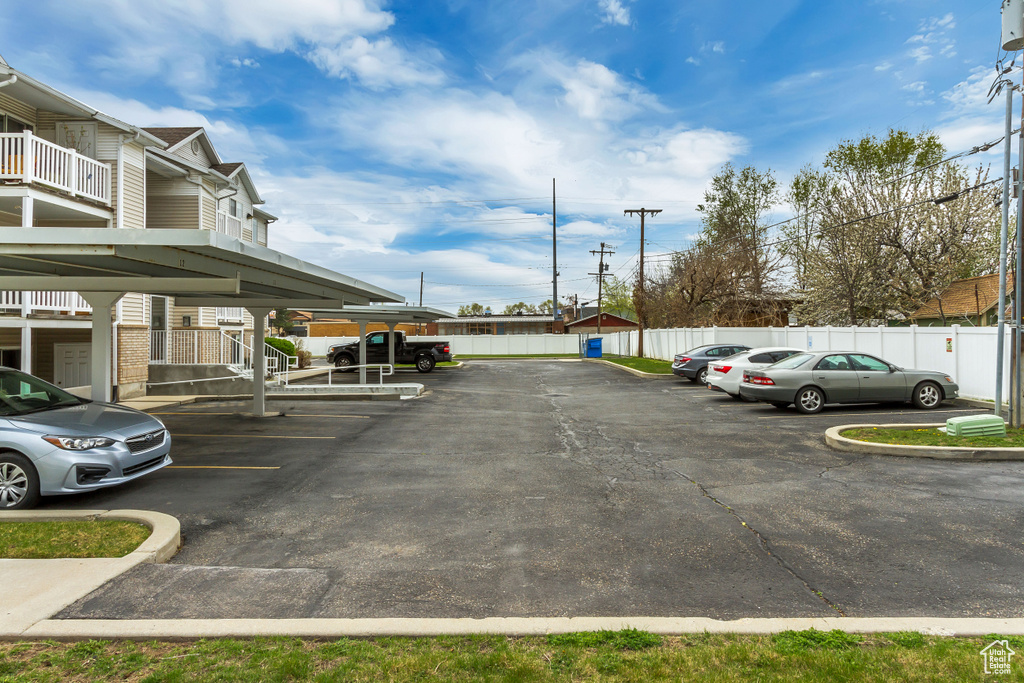 Partially covered parking lot featuring fence