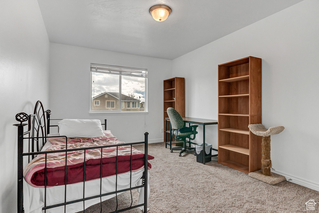 Carpeted bedroom featuring baseboards