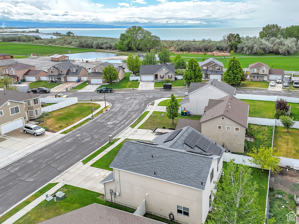 Aerial perspective of suburban area featuring a large body of water