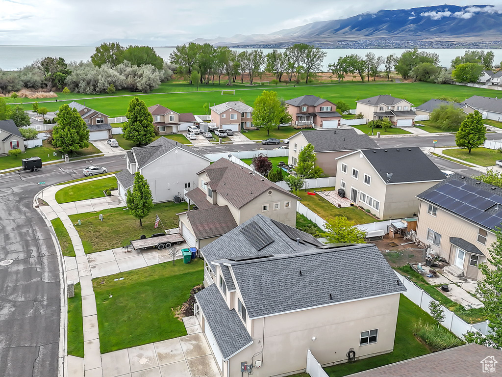 Aerial view of residential area featuring a nearby body of water