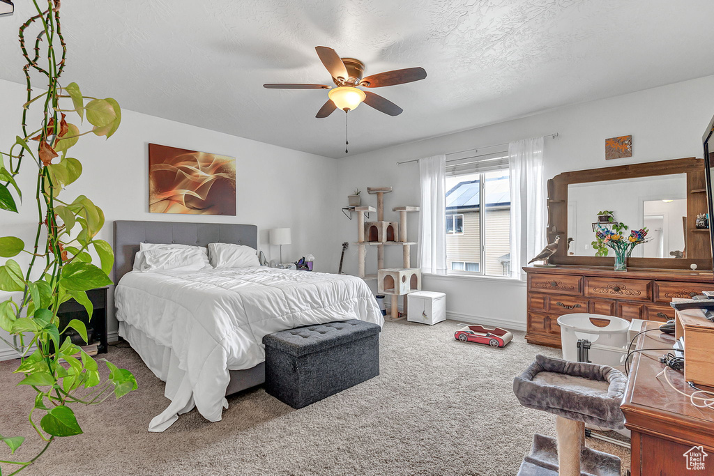 Bedroom with carpet flooring, baseboards, and ceiling fan