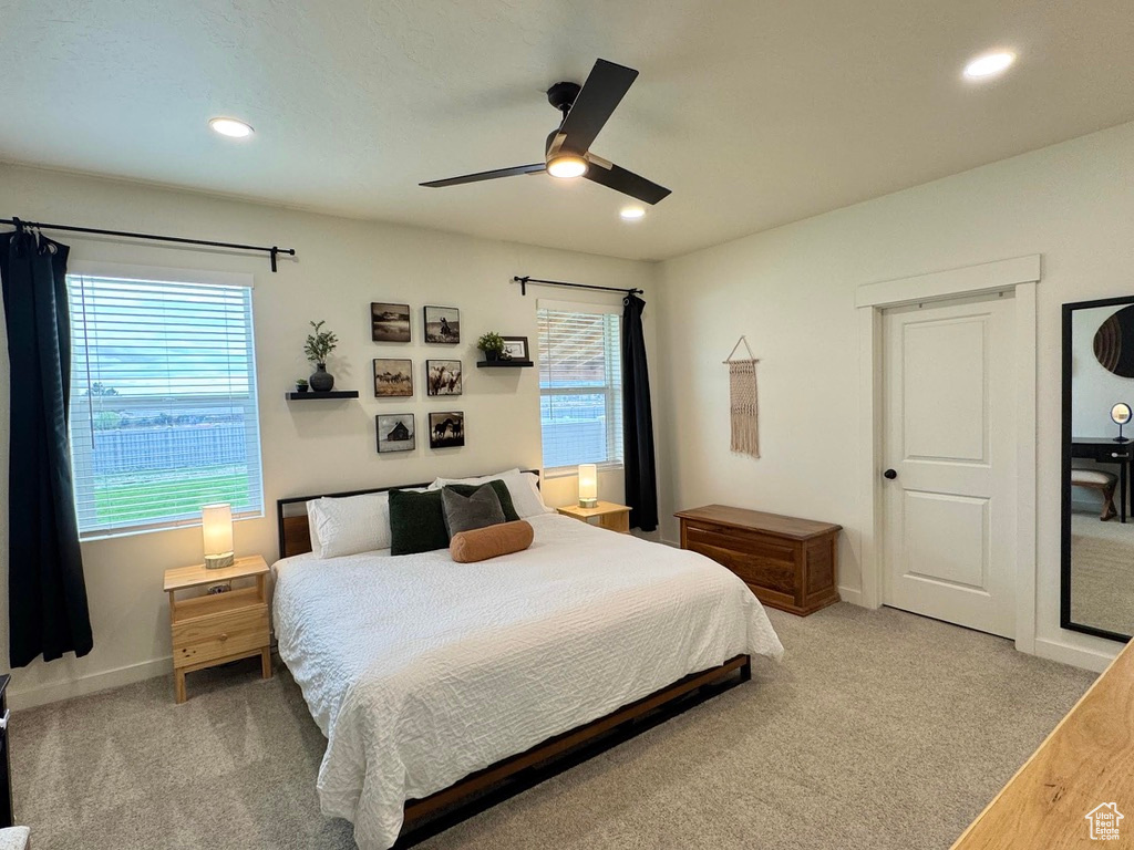 Bedroom featuring light carpet, recessed lighting, baseboards, and a ceiling fan
