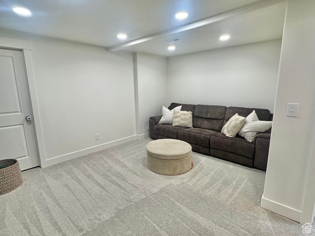 Living room with carpet flooring, recessed lighting, and baseboards
