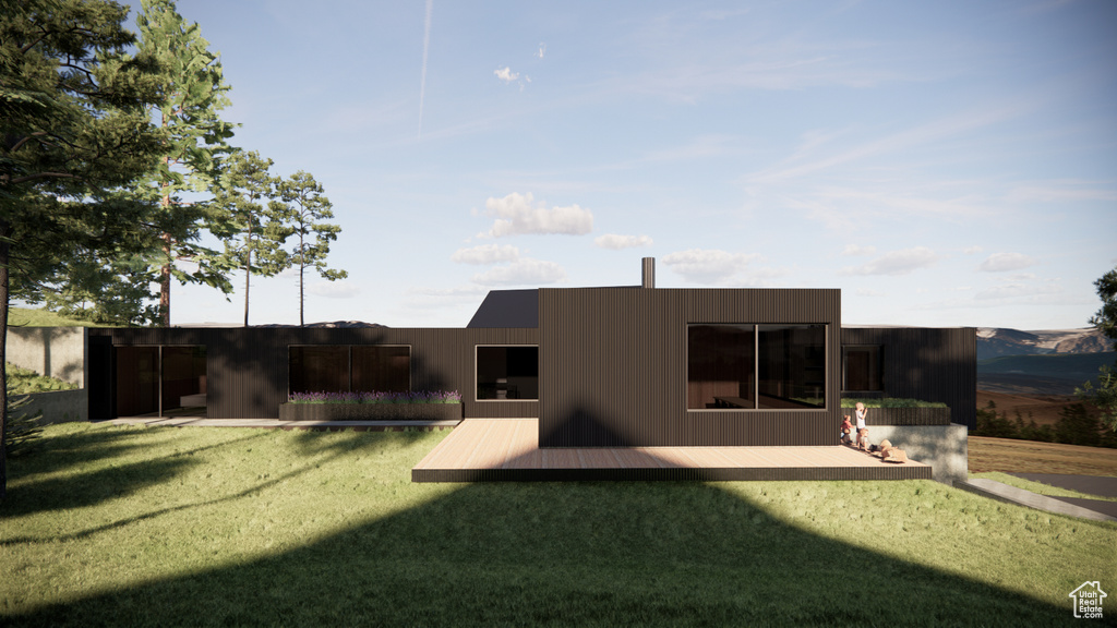 Back of property with a wooden deck and a yard
