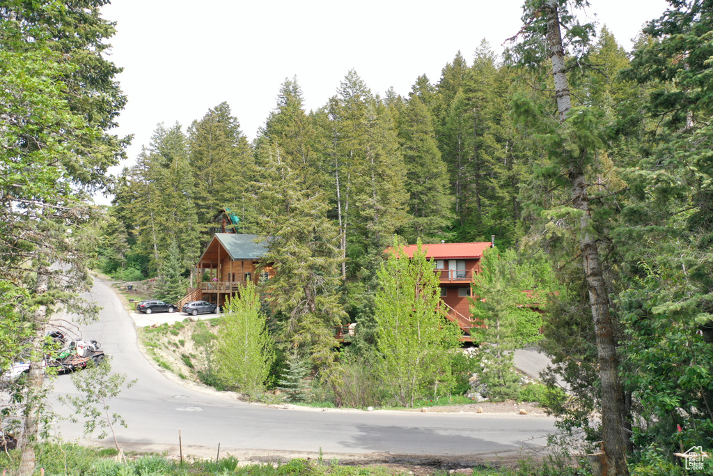 Aerial view of property and surrounding area featuring a heavily wooded area