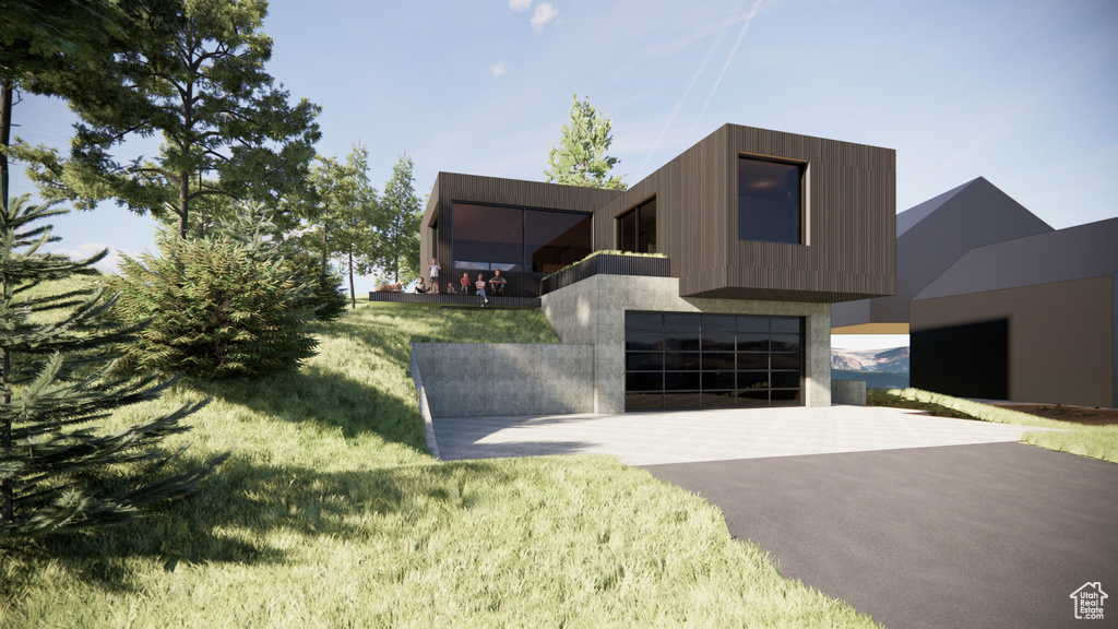 Contemporary house featuring driveway, a front yard, and a garage