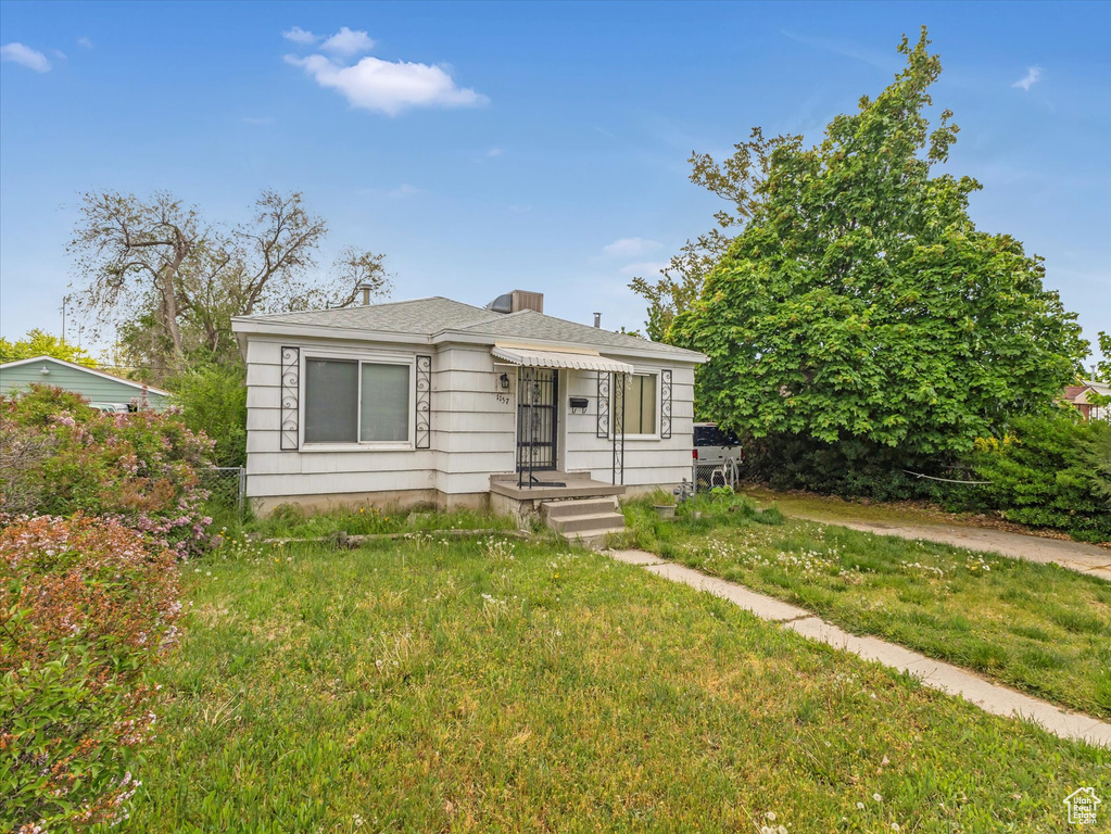 Bungalow-style house with a front yard