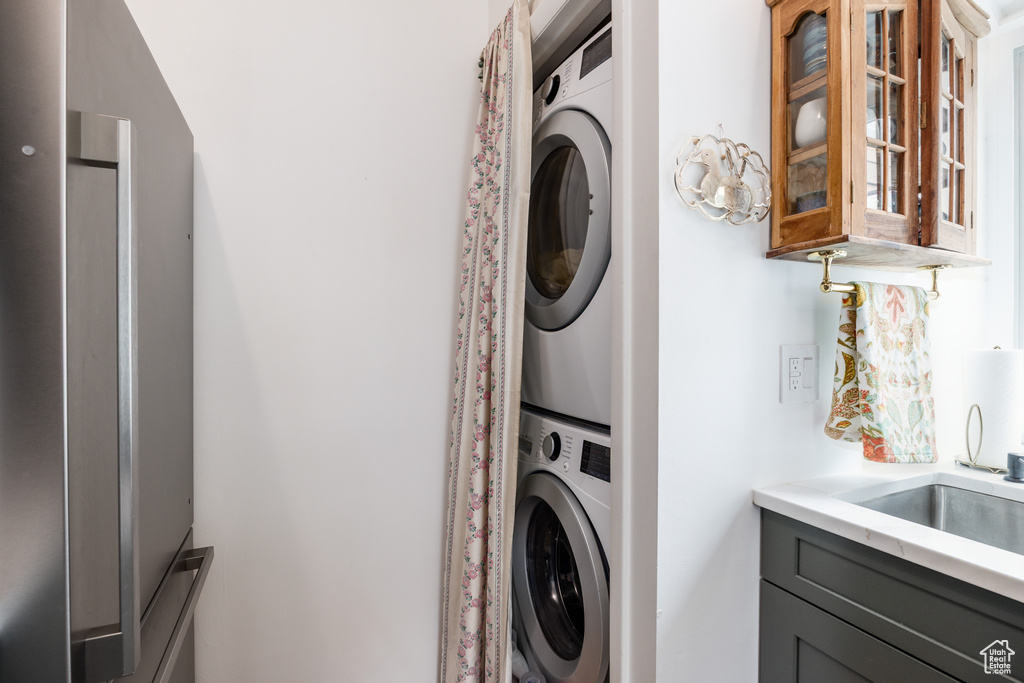Laundry area featuring stacked washer / drying machine