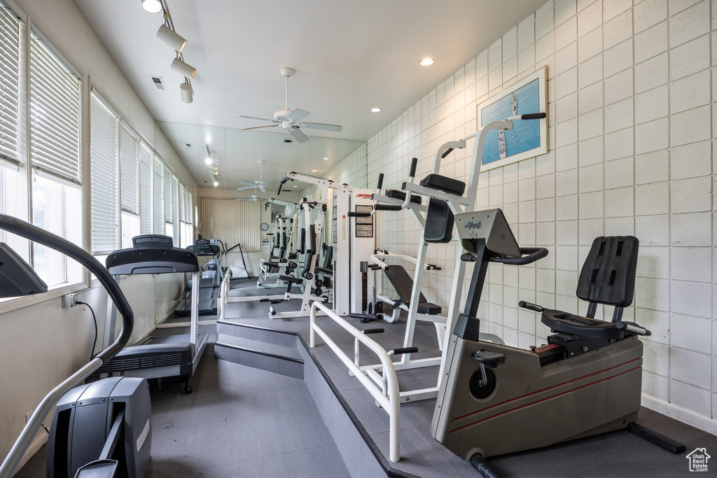 Gym with ceiling fan and recessed lighting