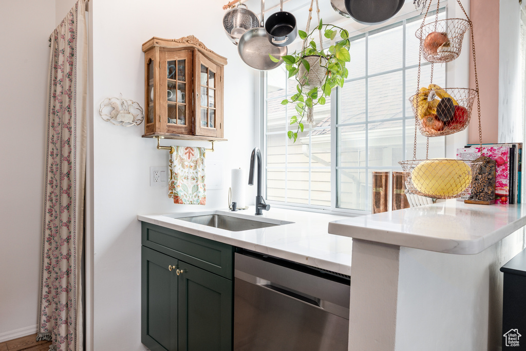 Bar area featuring dishwasher and a sink