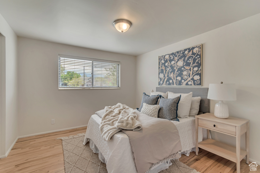 Bedroom featuring light wood finished floors and baseboards