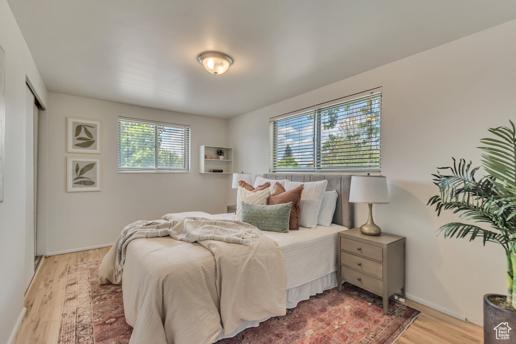 Bedroom with light wood-style flooring and baseboards