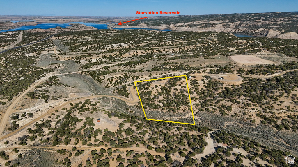 View of property location with a large body of water and property boundaries highlighted