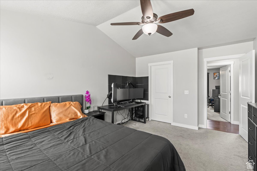 Bedroom with carpet floors, baseboards, ceiling fan, and lofted ceiling