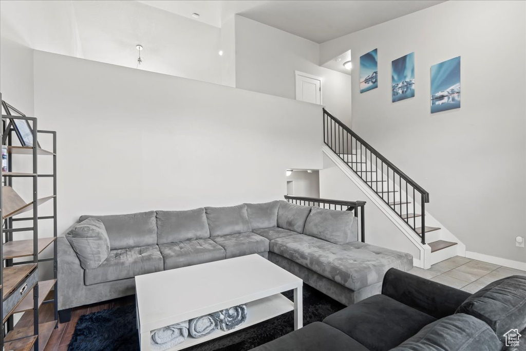 Living room with stairs and a high ceiling