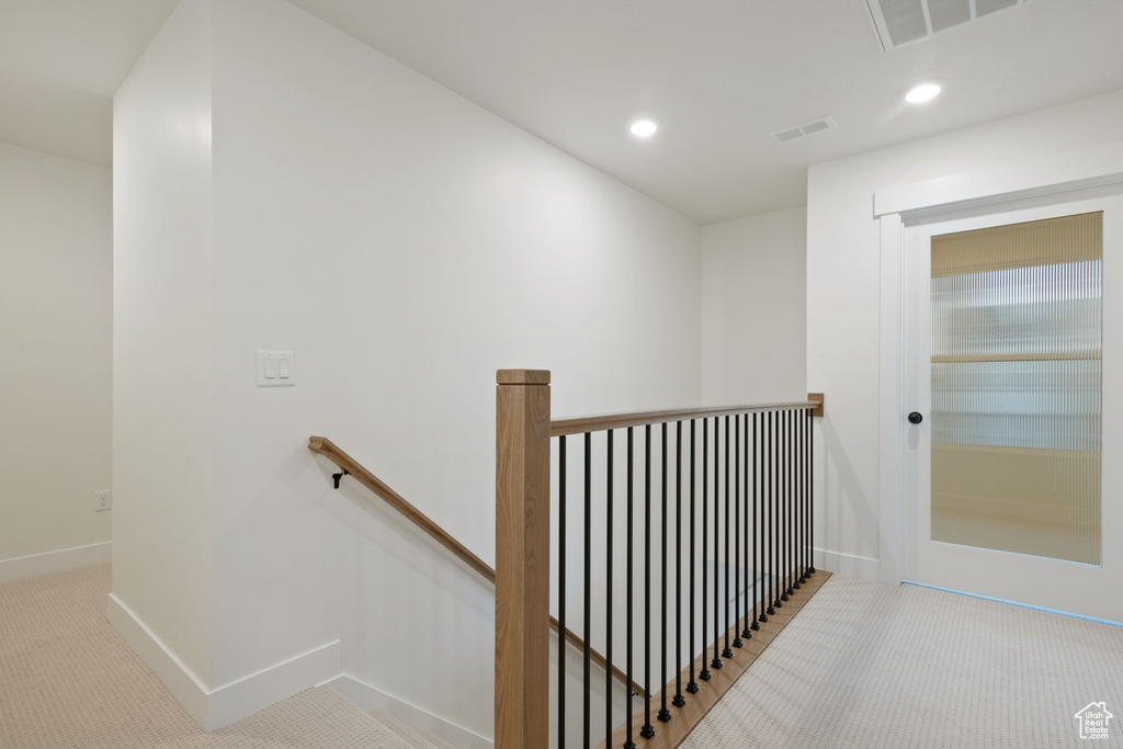 Hallway featuring an upstairs landing, recessed lighting, carpet floors, and baseboards
