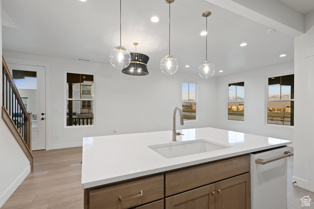 Kitchen with a sink, recessed lighting, plenty of natural light, and baseboards