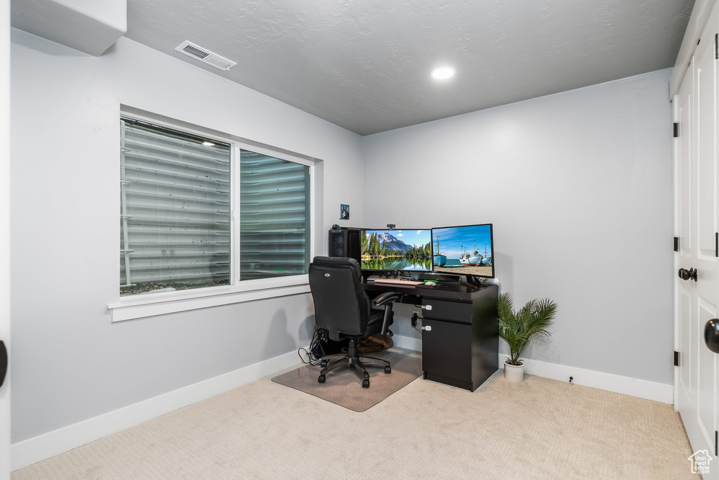 Office with carpet flooring and baseboards