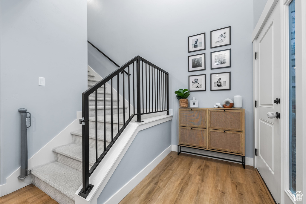 Stairway featuring wood finished floors and baseboards
