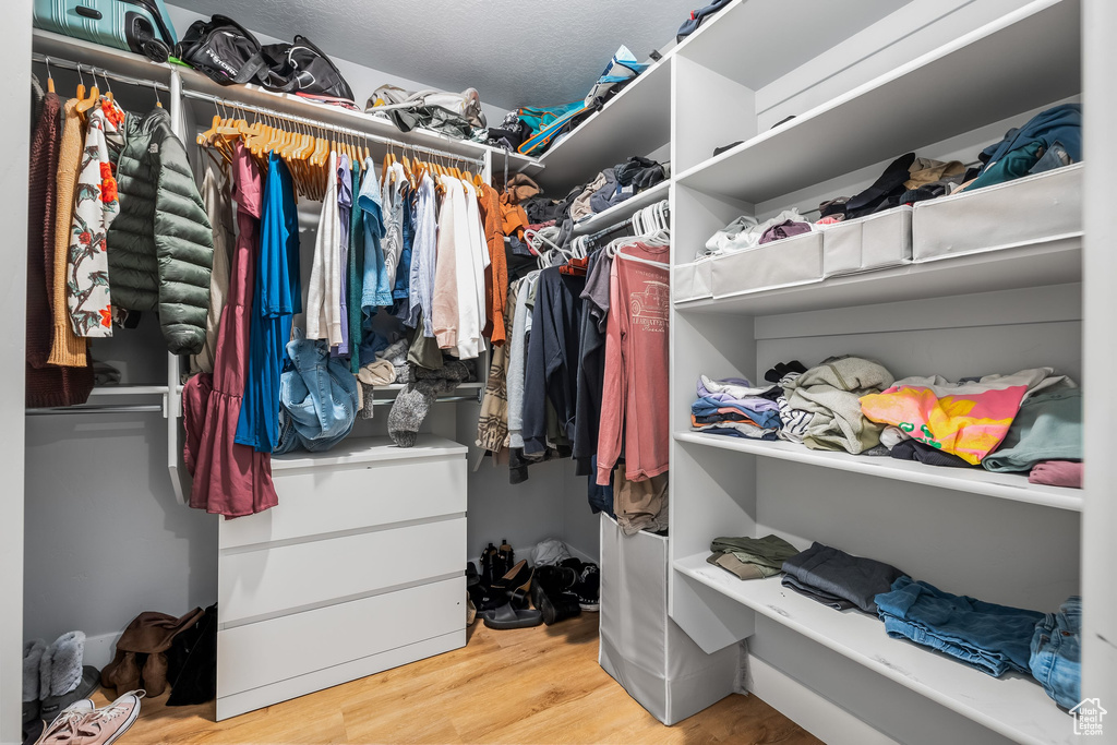 Walk in closet with wood finished floors