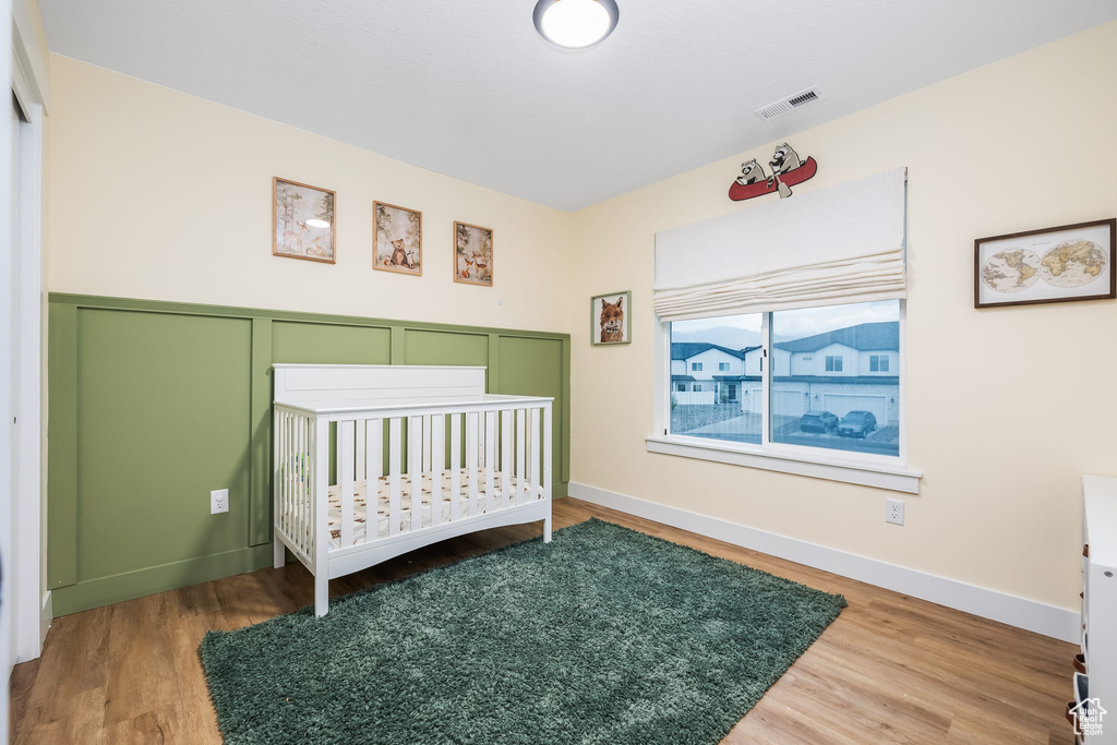 Bedroom featuring wood finished floors and baseboards