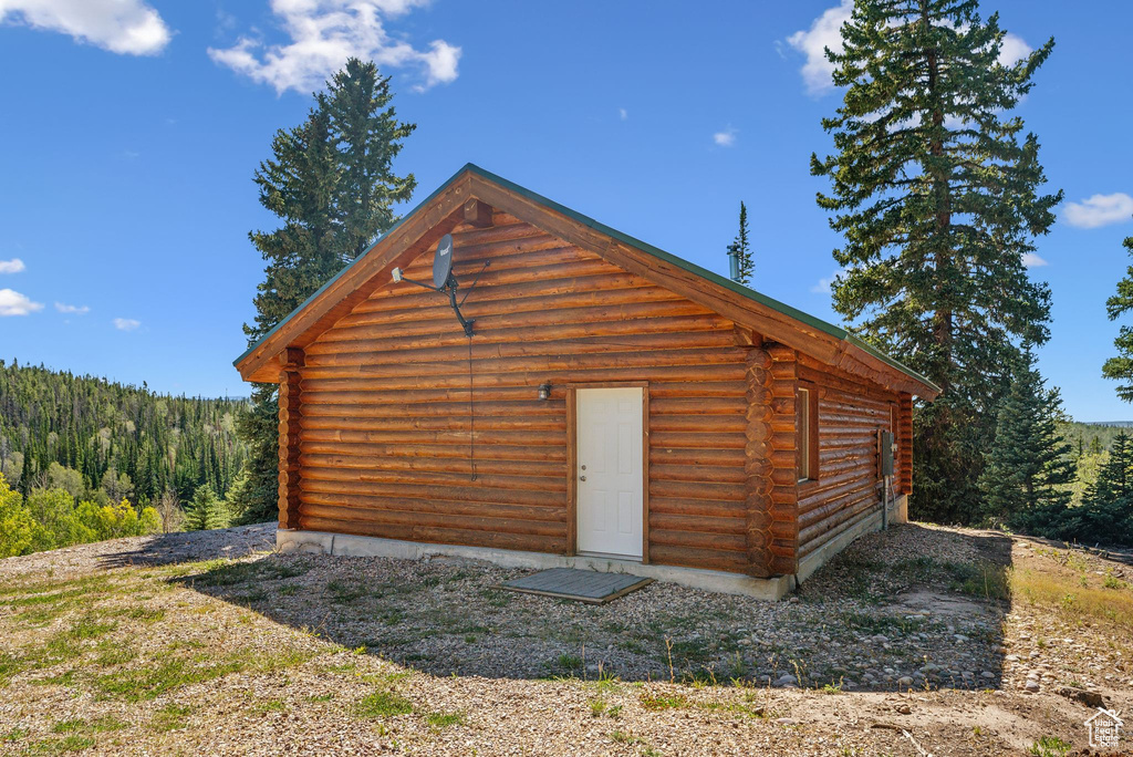View of outbuilding with a forest view and an outbuilding