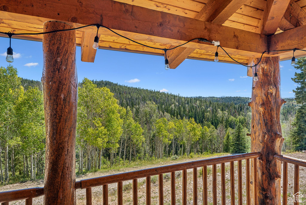 Wooden terrace featuring a view of trees
