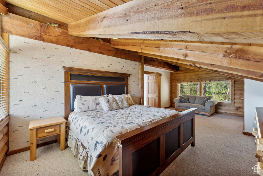 Bedroom featuring beamed ceiling, light colored carpet, wood ceiling, and wood walls