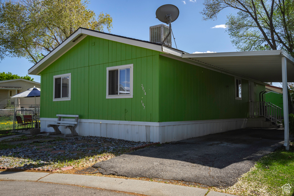 View of home\'s exterior featuring an attached carport and asphalt driveway