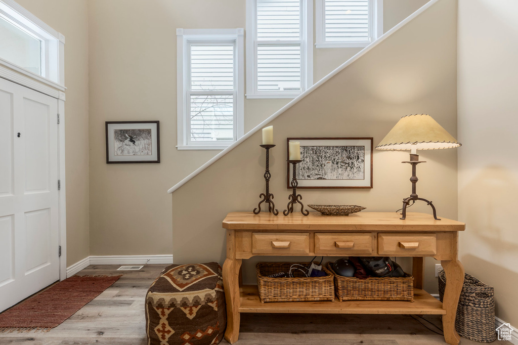 Foyer entrance featuring wood finished floors, baseboards, and stairway