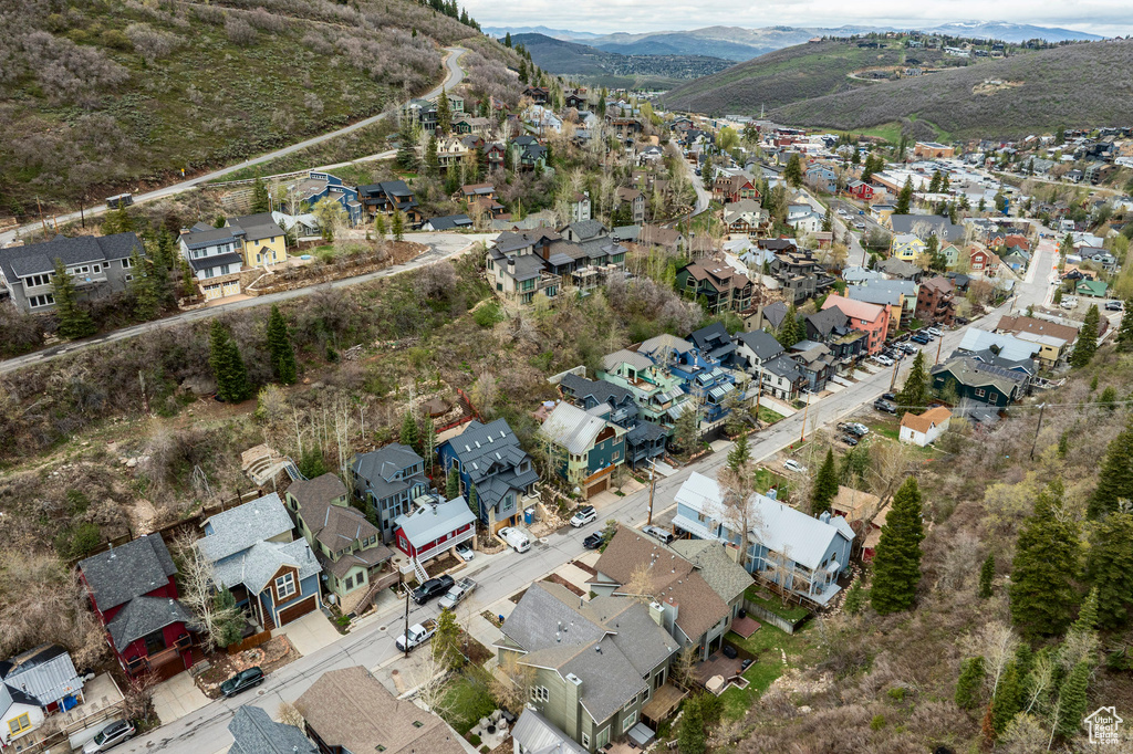 Aerial overview of property's location featuring nearby suburban area and a mountain backdrop