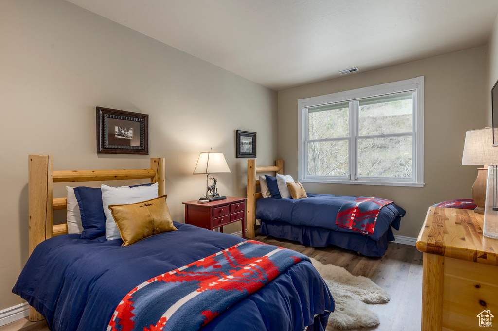 Bedroom featuring wood finished floors and baseboards