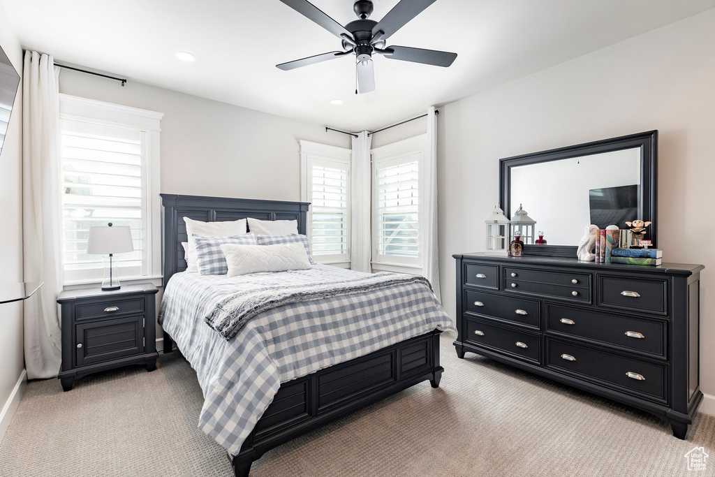 Bedroom with light carpet and ceiling fan