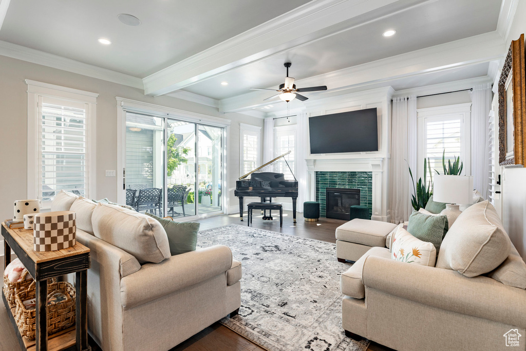Living room with beam ceiling, ornamental molding, a ceiling fan, recessed lighting, and wood finished floors