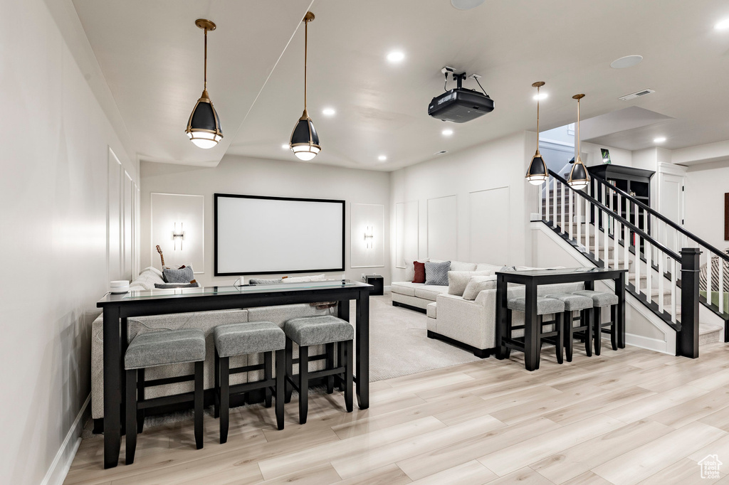 Cinema with light wood-style floors, recessed lighting, and baseboards